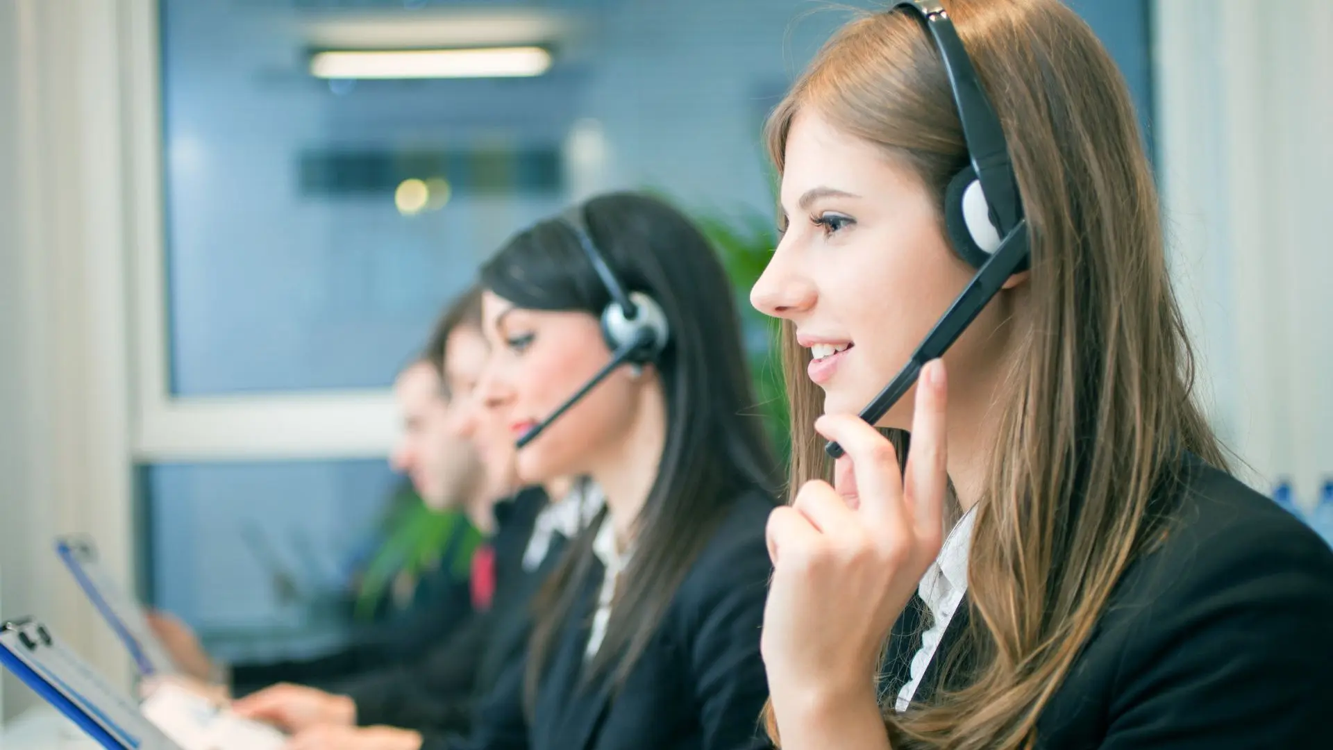 Tres mujeres con cascos y micrófono hablan de los diferentes servicios de una empresa de traducción e interpretación