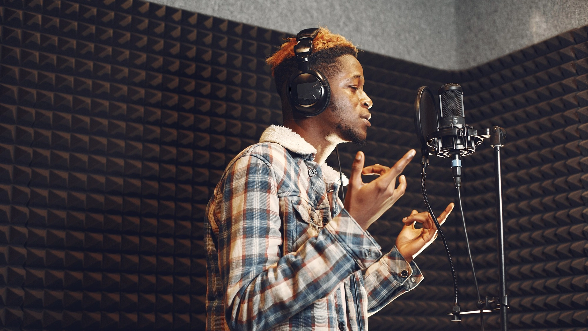 A man in a recording studio recording a translation for audiovisual content
