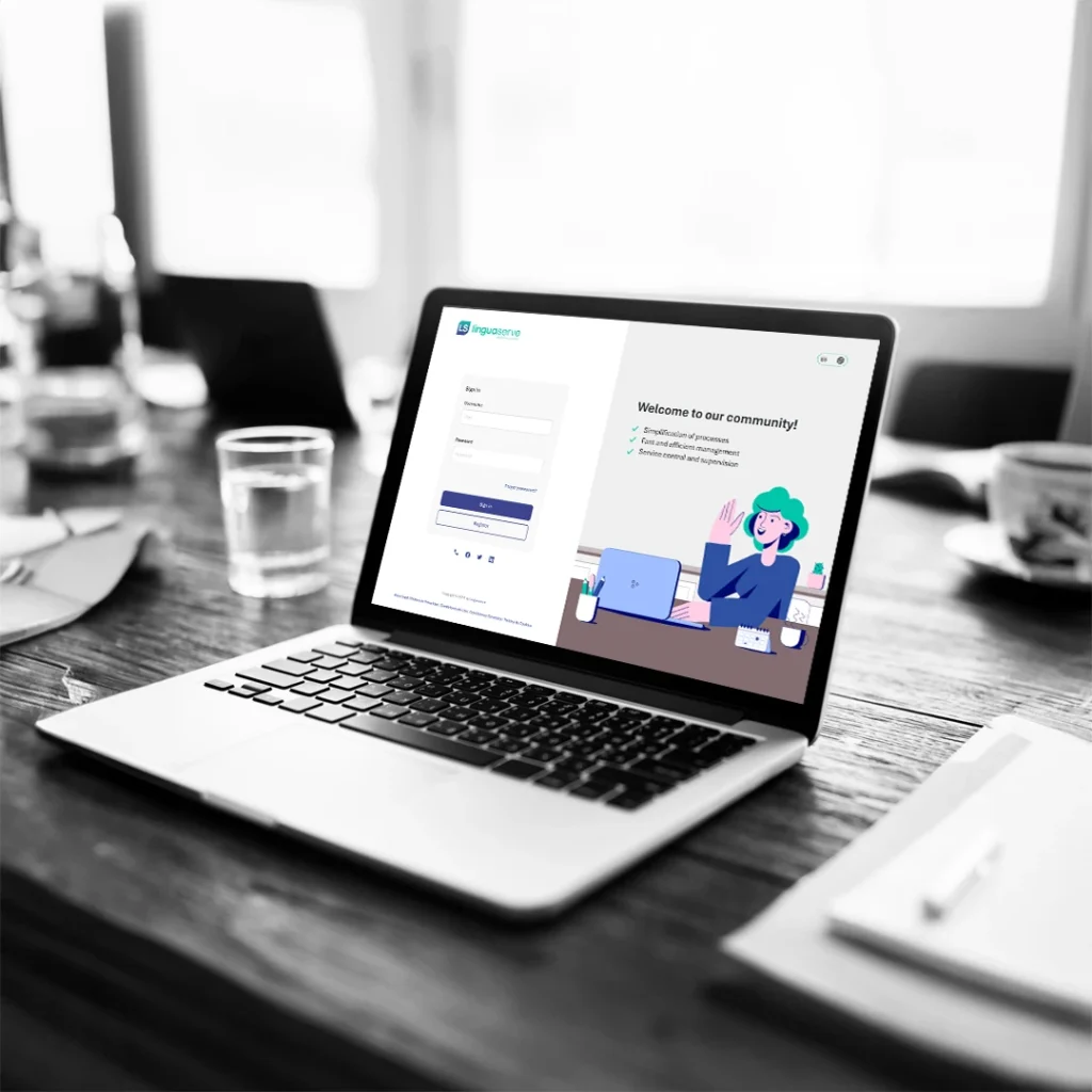 A laptop displaying the Linguaserve customer login page on a table with documents and cups